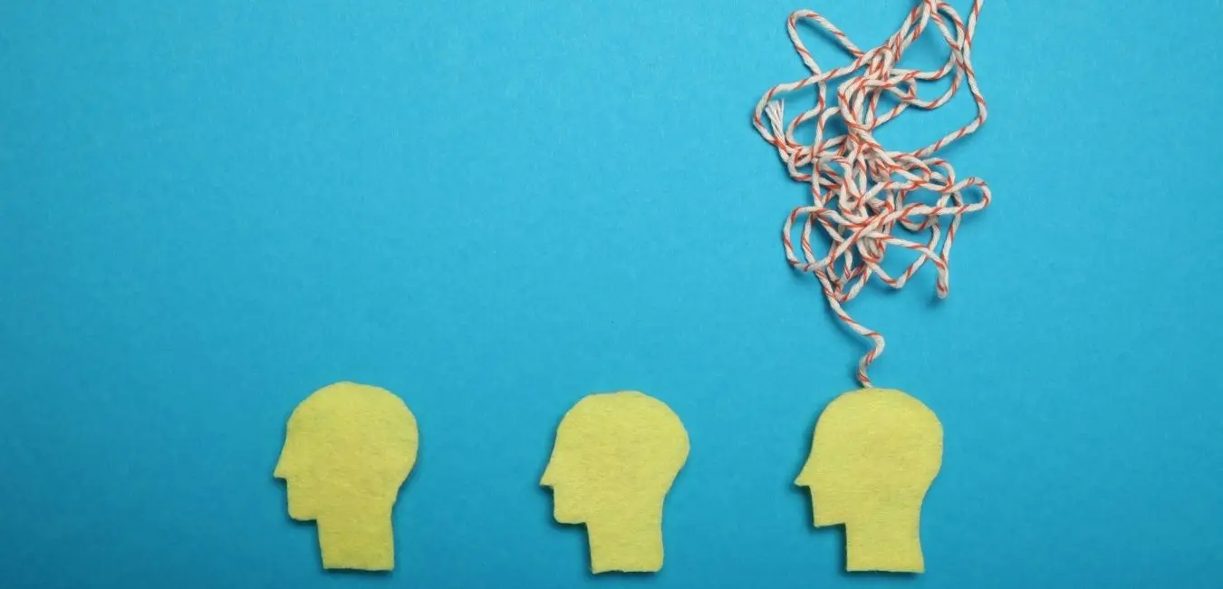 Cut out images of heads with string on blue background